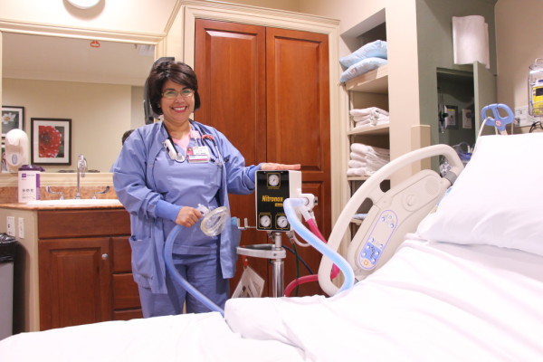Nurse standing by hospital bed