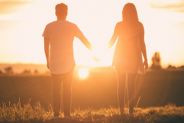 sunset couple holding hands