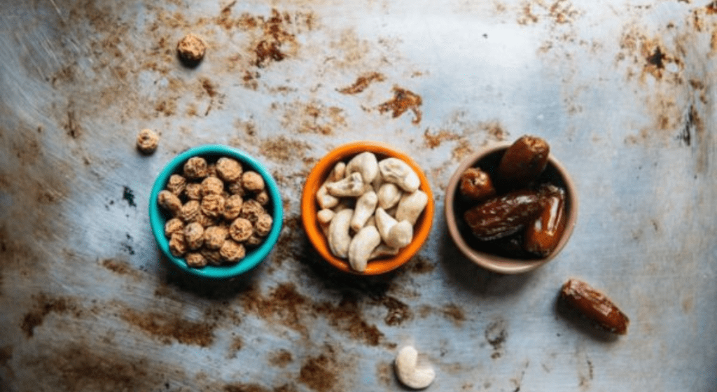 Bowls of peanuts, cashews, and dates -- common food allergies