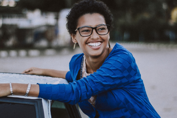 woman smiling by car horizontal
