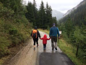child walking with parents