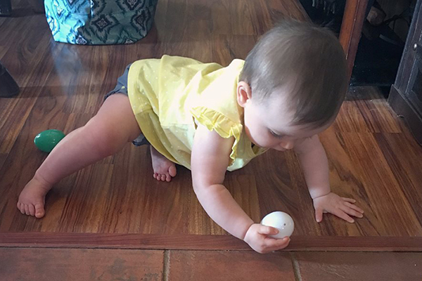 baby girl holding egg