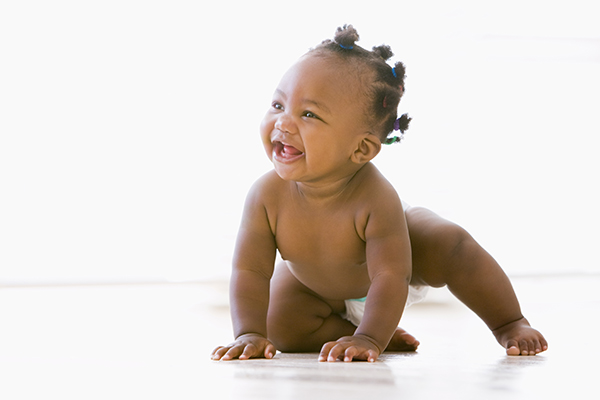 baby smiling and in crawl pose