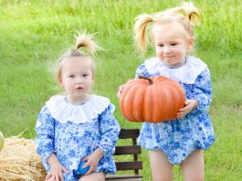 twins carrying pumpkins