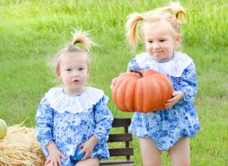 twins carrying pumpkins
