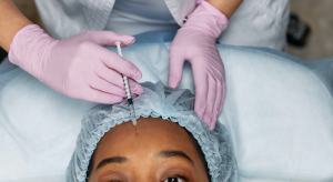 Women receives botox injections in her forehead