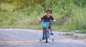 Some kids may be delayed when riding their bike.