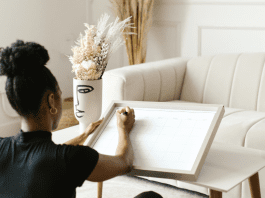 A woman write a calendar on a white board.