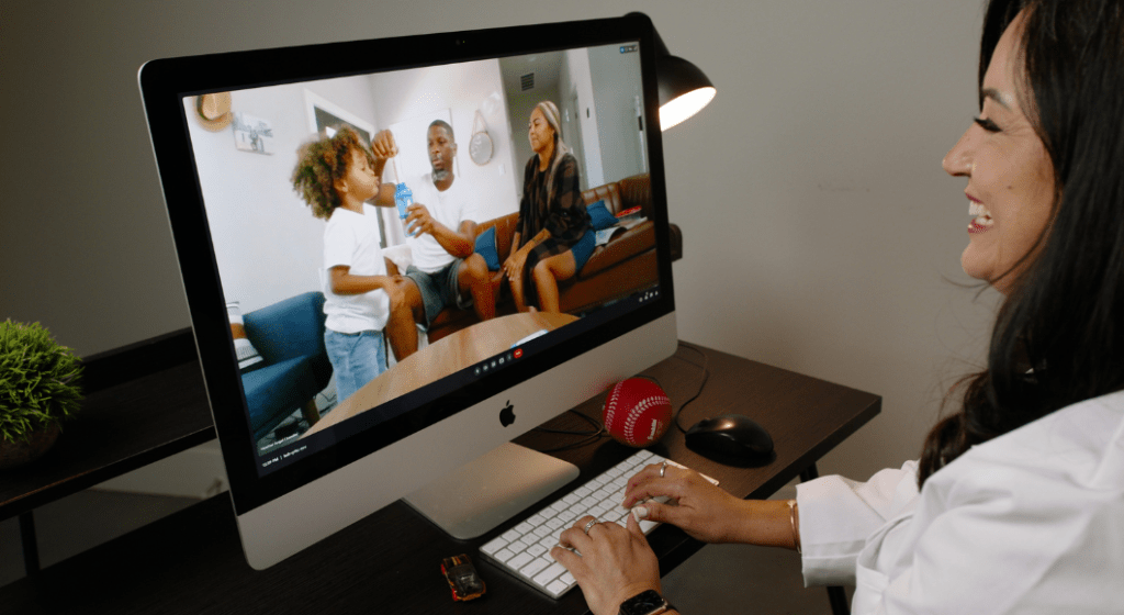 A telehealth provider virtually meets with a family.