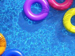 overhead view of a pool with colorful inner tubes