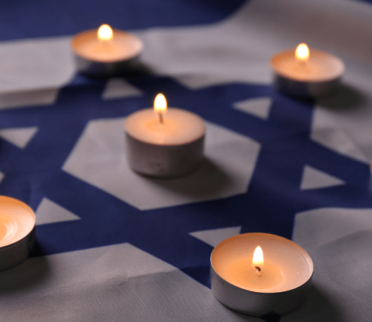 Tea candles are lit on the Star of David for Holocaust remembrance.