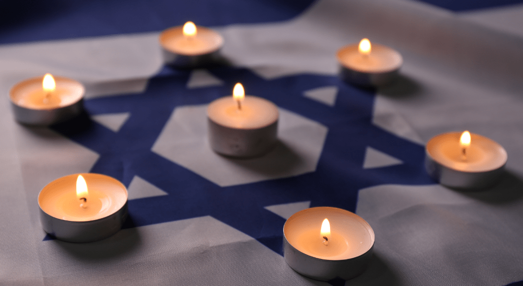 Tea candles are lit on the Star of David for Holocaust remembrance.