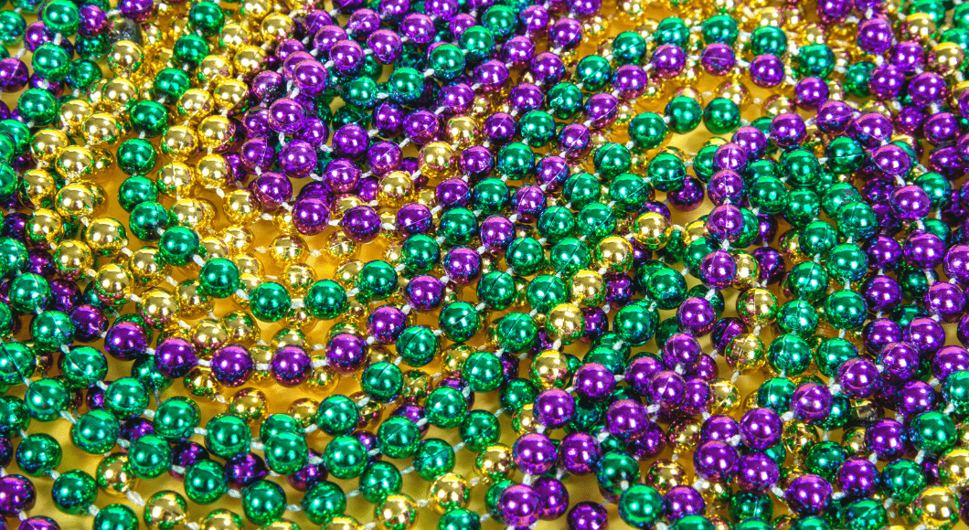Green, purple and gold Mardi gras beads swirled.