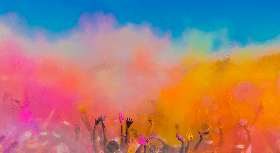 Holi celebration with colorful powder in the air.