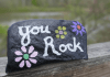 A rock painted with the words "You Rock."