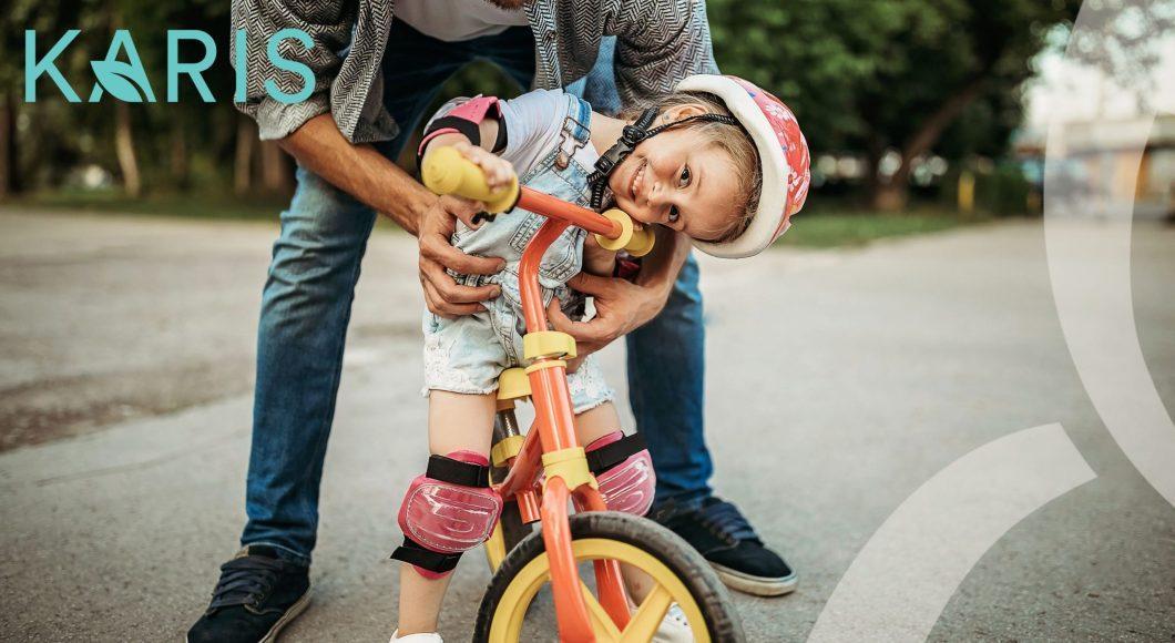 A child rides a balance bike in Karis master-plan community.