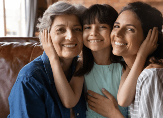 A young girl in the middle of her grandmother and mother