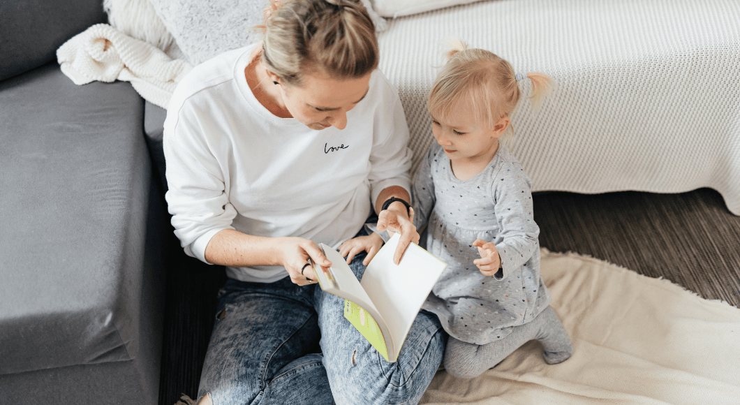 Mom reading to toddler. 