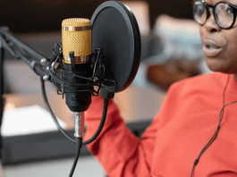 Black mom talking into a podcast microphone