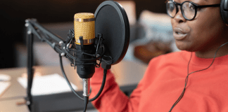 Black mom talking into a podcast microphone