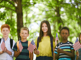 Five kids holidng American flags