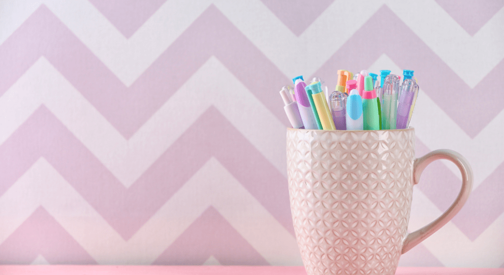 Colorful pens in a mug are a thoughtful gift for teachers
