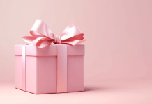 A gift wrapped in pink with a big pink bow.